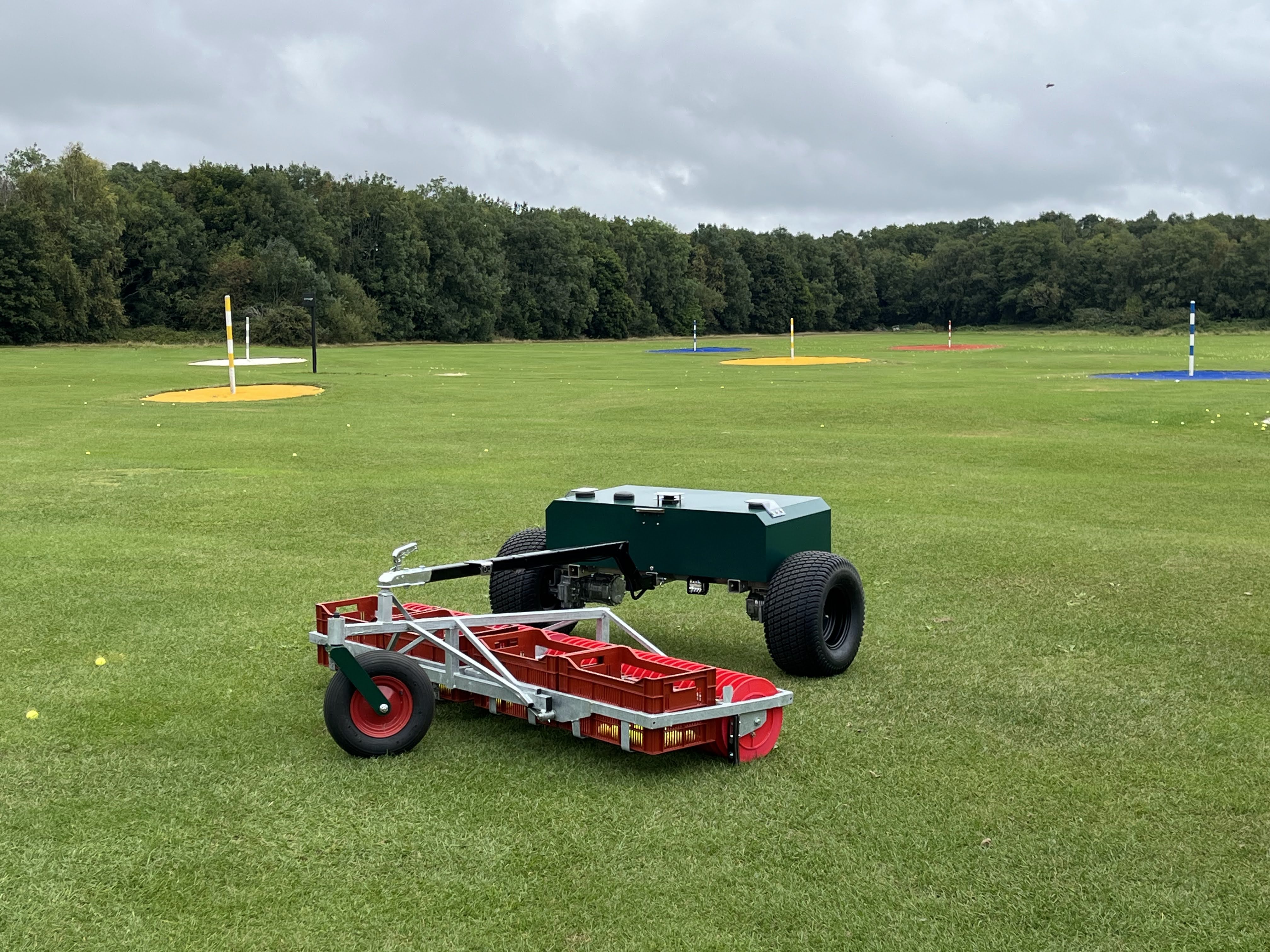 Robotic golf ball picker collecting balls on driving range